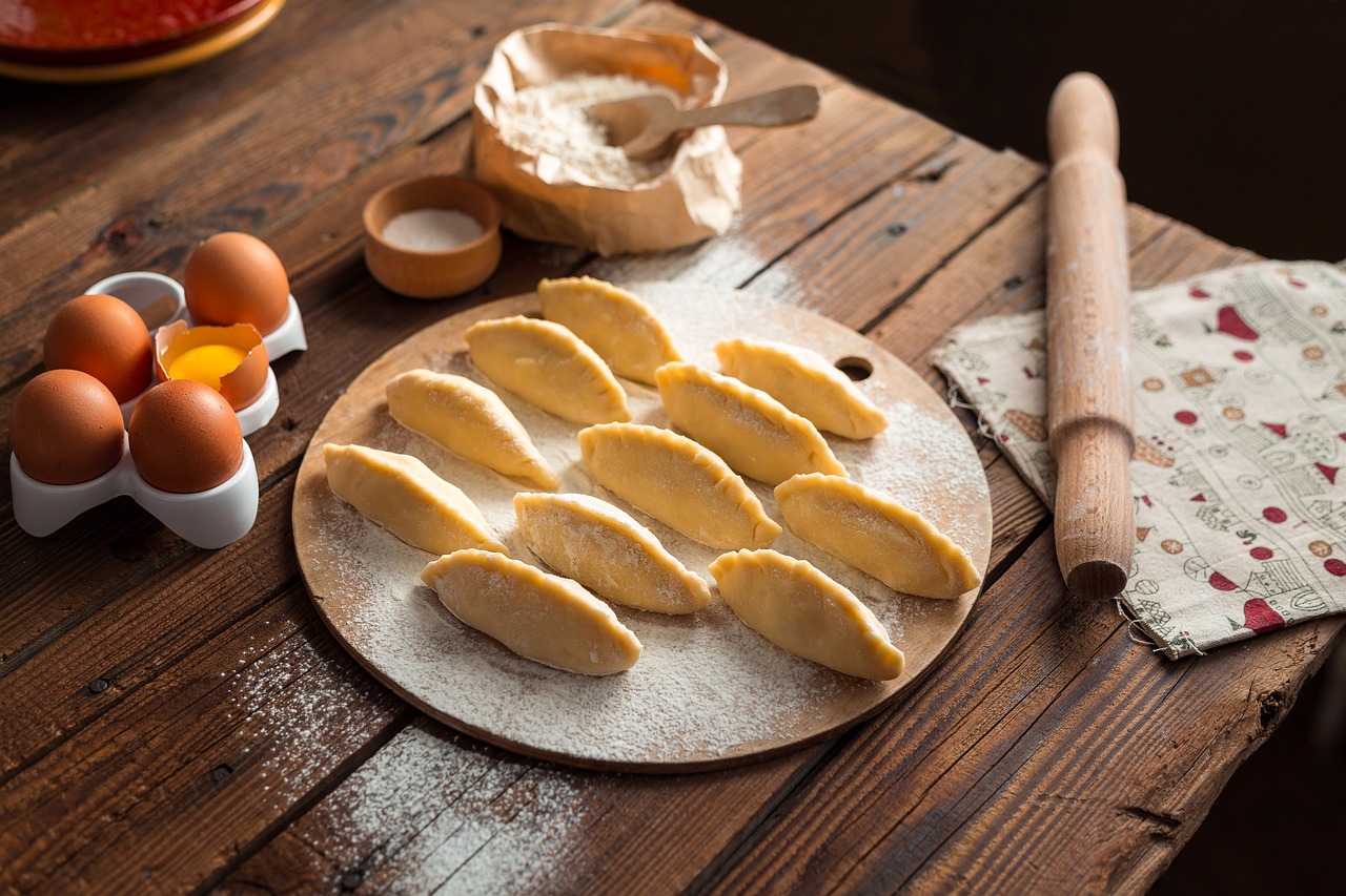  A wooden table displaying raw dough and eggs, ready for baking preparations